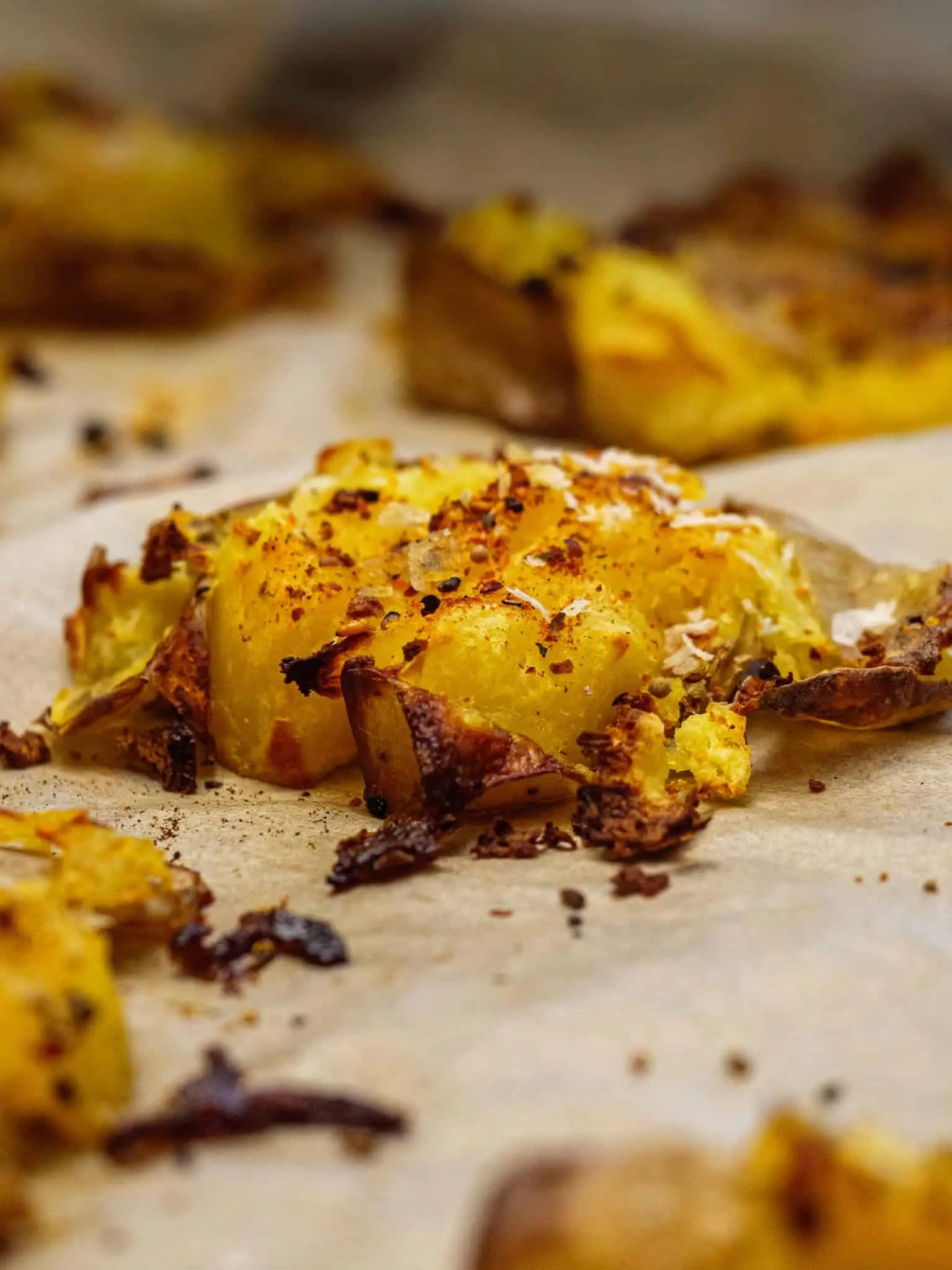 Golden brown smashed potatoes cooked in an air fryer.